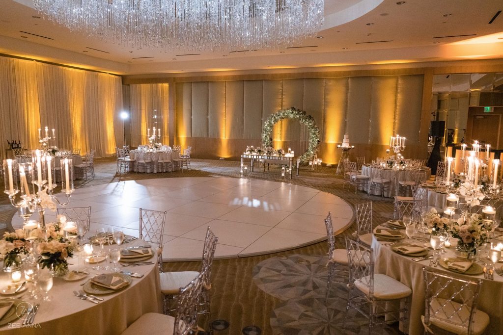 wedding ballroom with dance floor, white flowers and candles